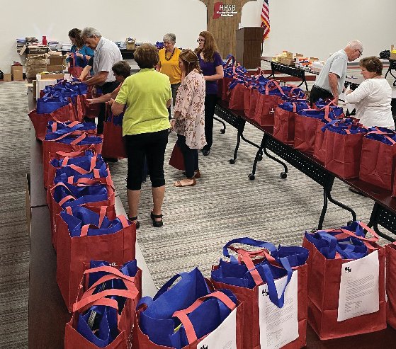 MCEF board members fill bags with school supplies at HHSB Success Center